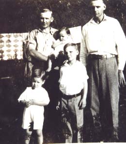 June Garrett (holding Phleze) with his brother, Esmer Garrett and Harold & Donald Garrett (infront of June)