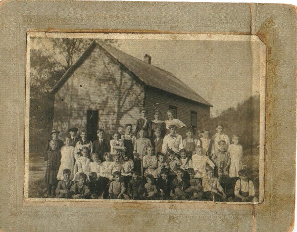 This picture was taken in a school yard somewhere in Estill County. In the last row of children, the boy from the left with the hat on is my father, Lloyd Patrick. From What I have been told, his family goth their mail at Panola. Can anyone identify any of the other people in this photo?