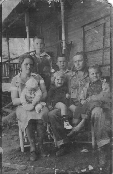 Standing are Hubert and Riley Reece, sitting Elfra Geneva (Stacy) Reece on her lap is daughter Nancy Reece, Charlie Reece with Anna and Ray Reece on his lap.